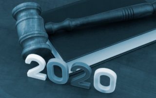 gavel rests on law book in the year 2020