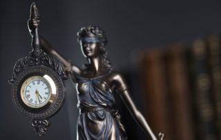 Lady Justice holding a clock